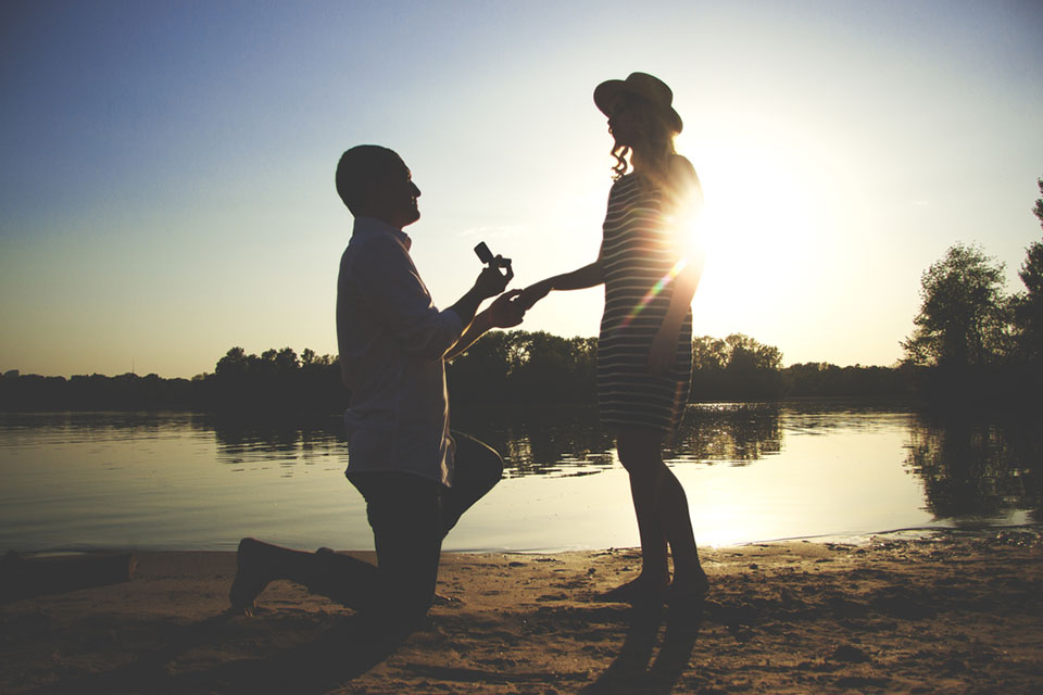 man proposing on lake side